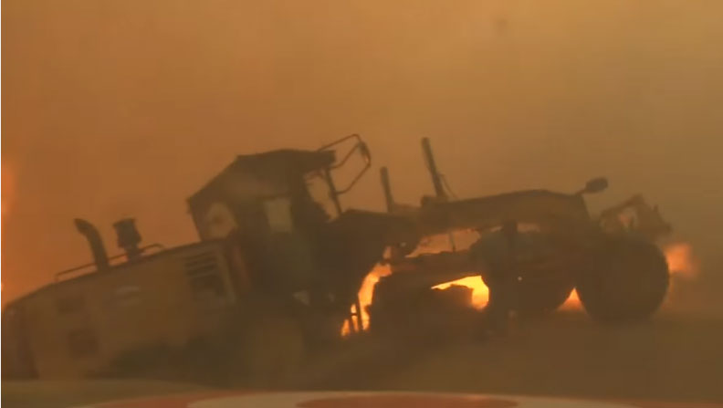 Man escapes Komatsu Road Grader before wild fire engulfs machine