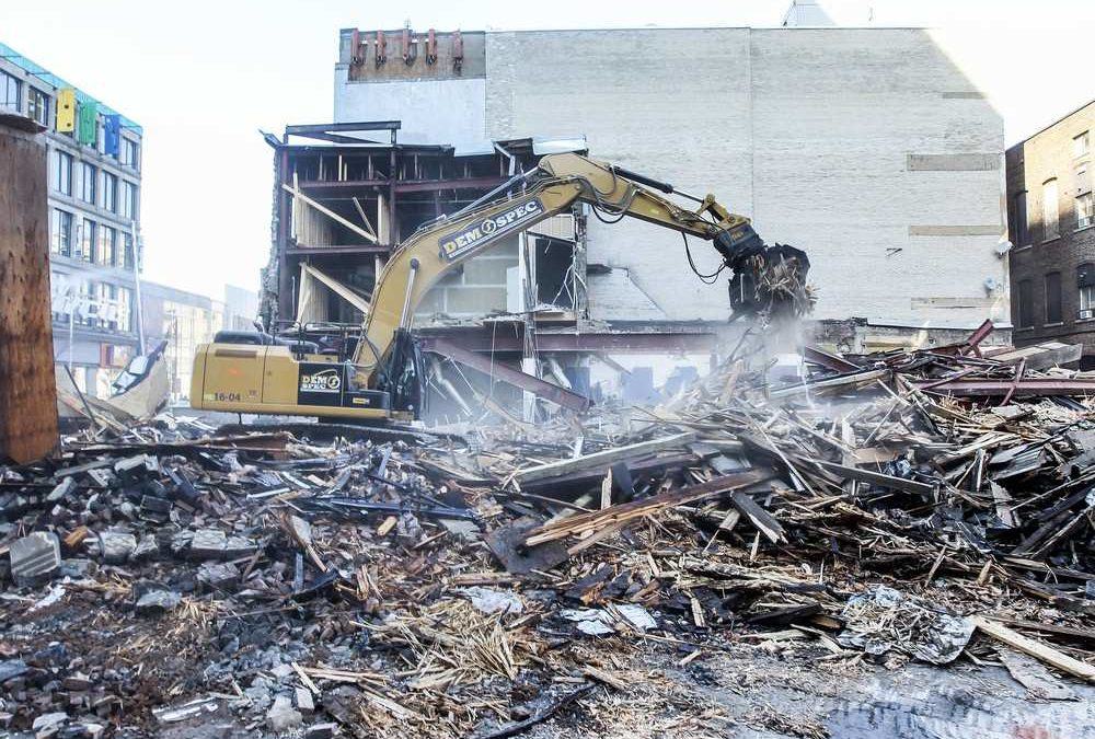 A downtown Montreal building collapsed as it was being razed by an excavator