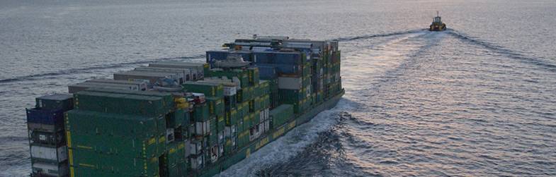 A Crane set to unload a barge takes a plunge in Ekuk, Alaska