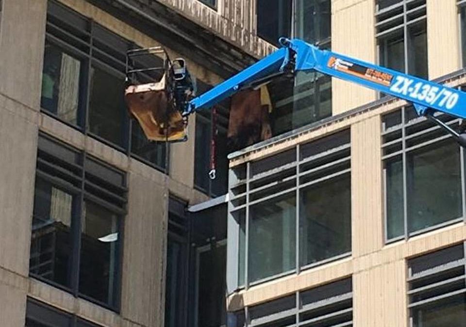 Construction workers jump to safety from articulating boom lift basket in downtown Boise
