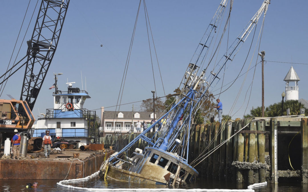 An American 7260 Crawler Crane mounted on a barge works to raise Three Girls in Georgia