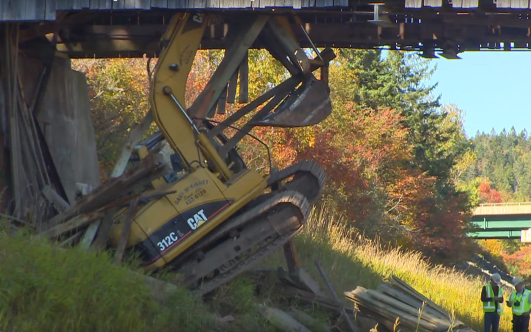 CAT 312C L excavator crashes through wooden bridge in New Brunswick, Canada