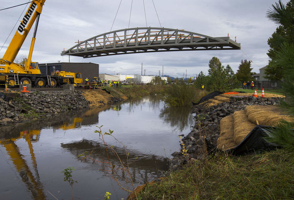 A Demag AC 435 operated by Oldham Crane Service, Inc. sets a new foot bridge in Eugene, Oregon