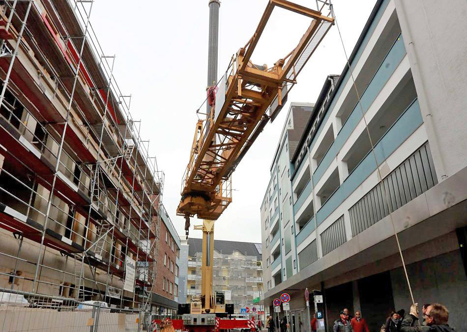 A Hess owned All Terrain Crane assembles a tower crane in Germany