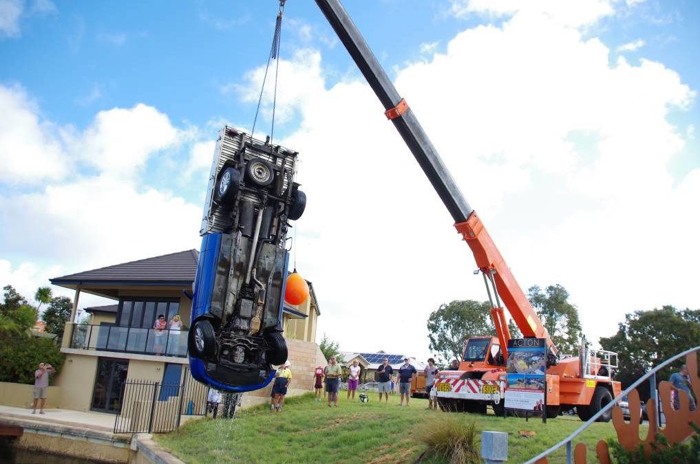 Pictures of a Pick N Carry Crane retrieving a pick up that rolled into a canal south of Perth, AU