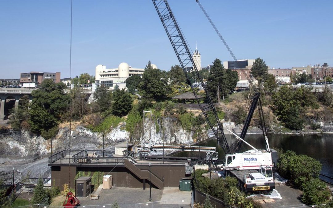 A Rhodes Crane 250-ton Link-Belt HC-268 lattice boom truck crane dredging on the Spokane River
