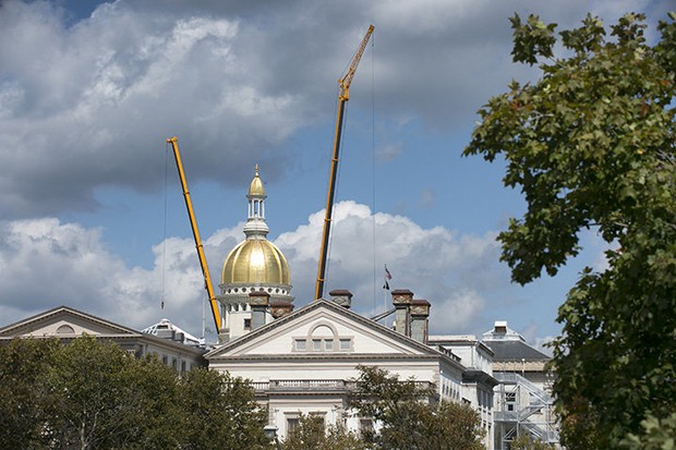 New Jersey’s shiny golden dome flanked by two All Terrain Crane in Gov. Chris Christie’s $300M Statehouse renovation project.