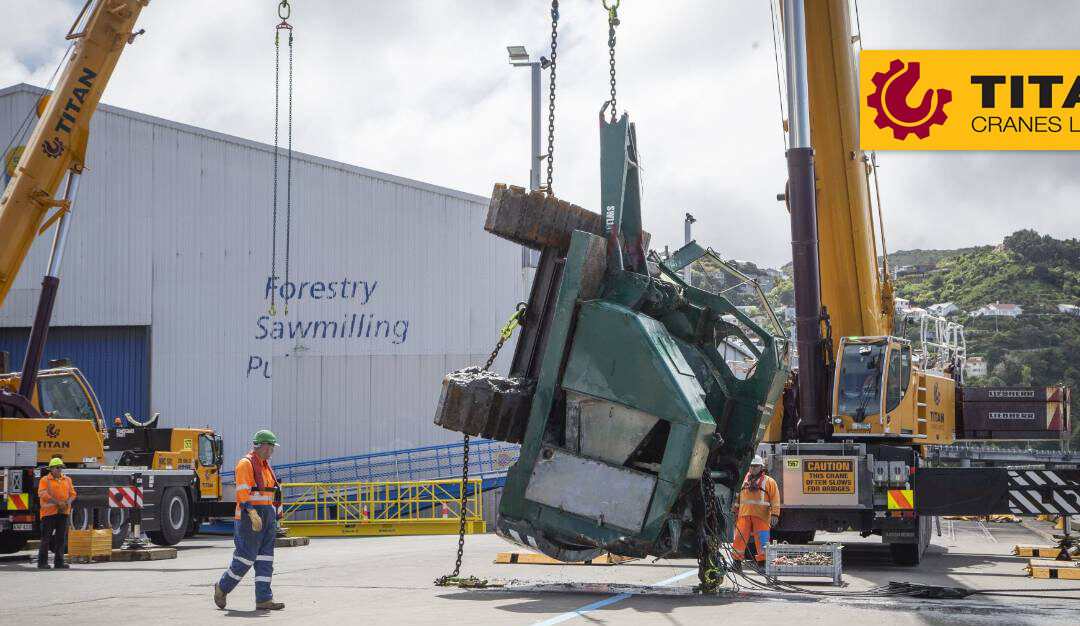 Titan Cranes Limited Liebherr LTM 1350-6.1 lifts 25-ton crawler crane out of Wellington Harbor in New Zealand